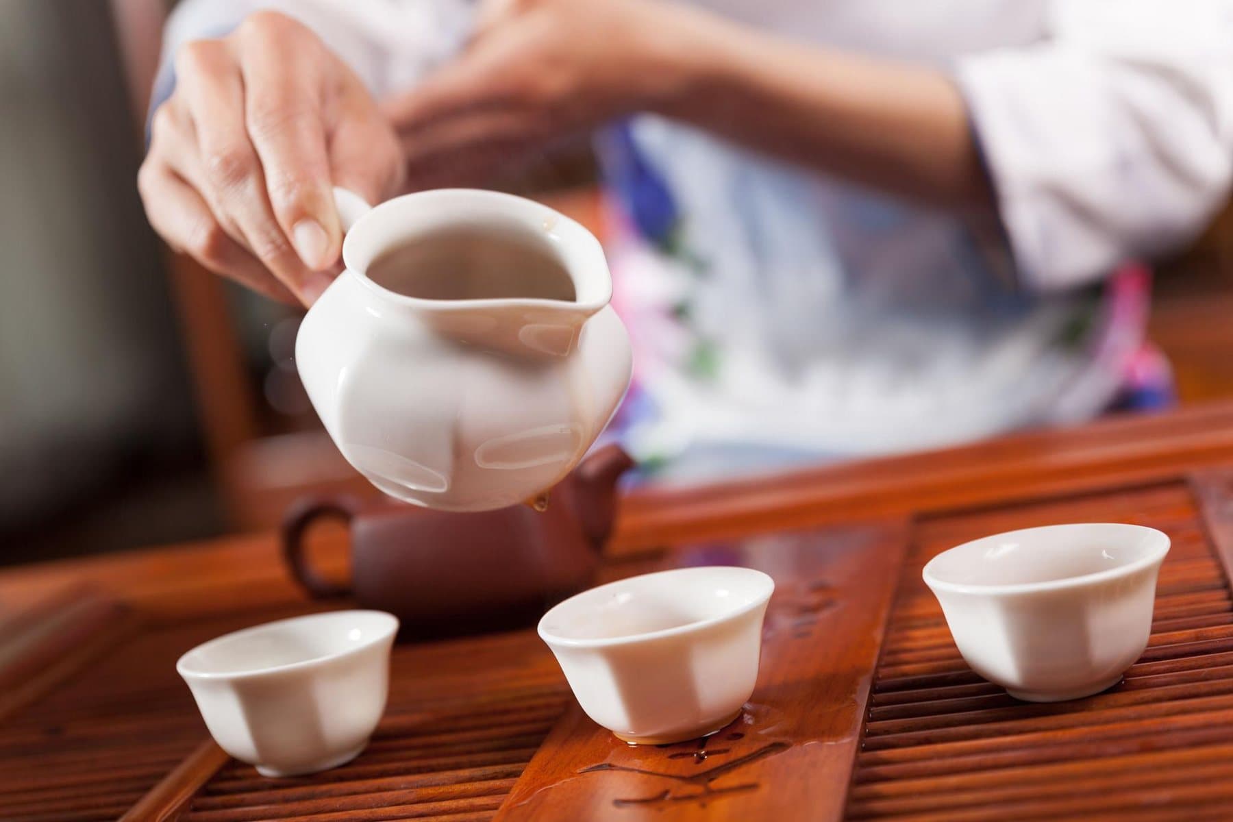 Pu’er Tea — Pu’er tea being poured into small cups