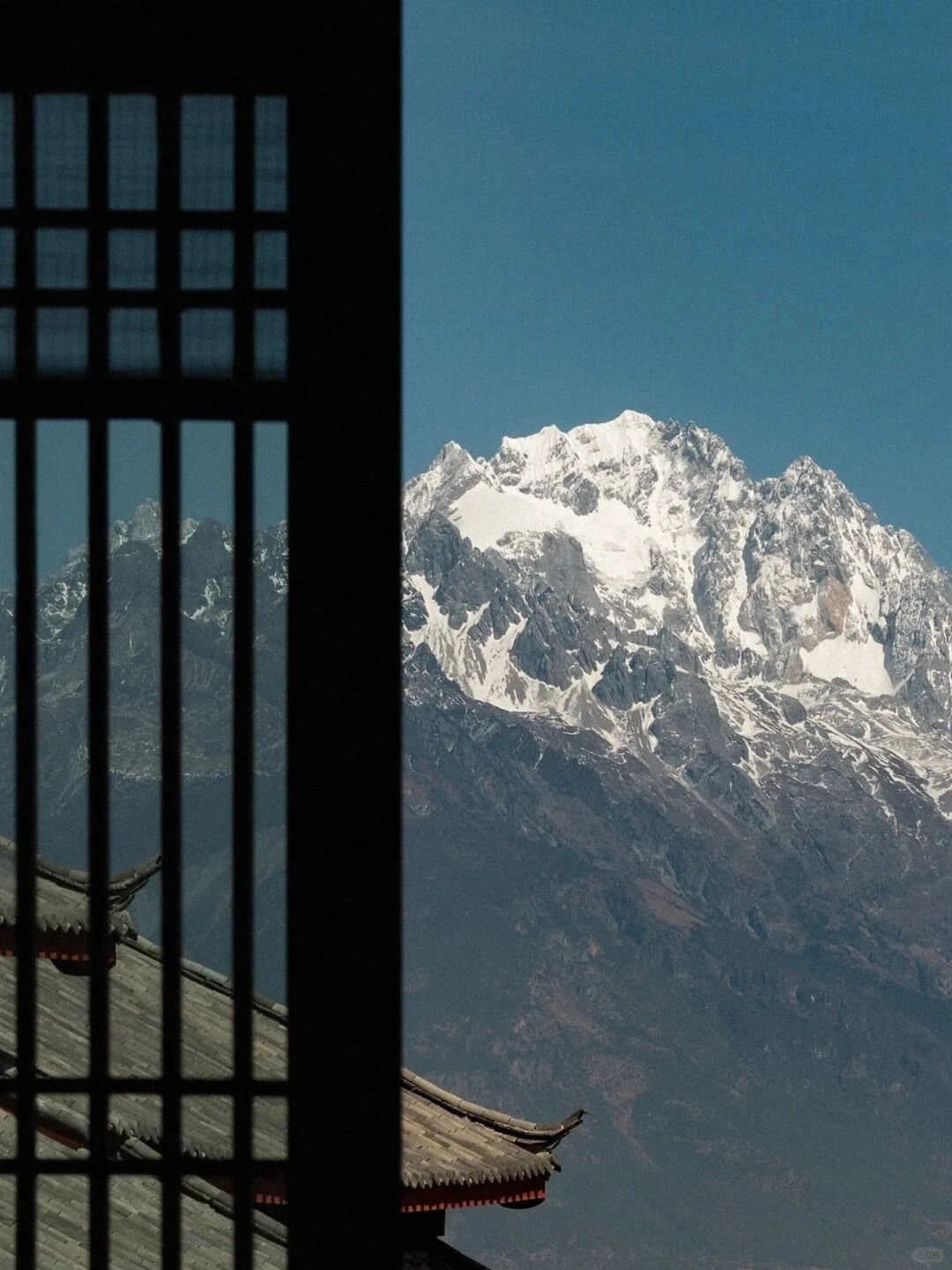 Yunnan Spring Markets — Jade Dragon Snow Mountain seen from a market doorway