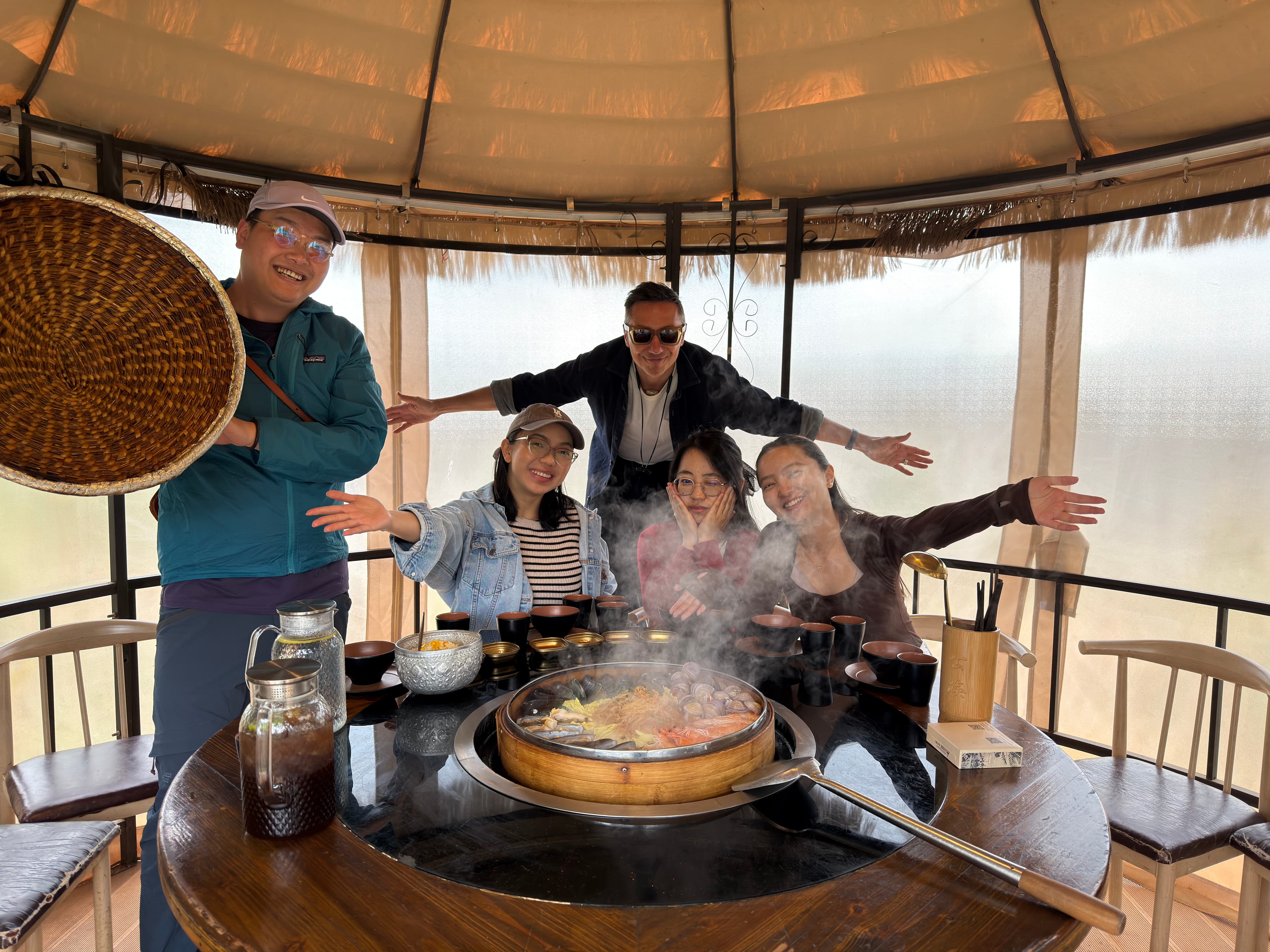 Travelers enjoying a hot pot meal in a Yunnan courtyard