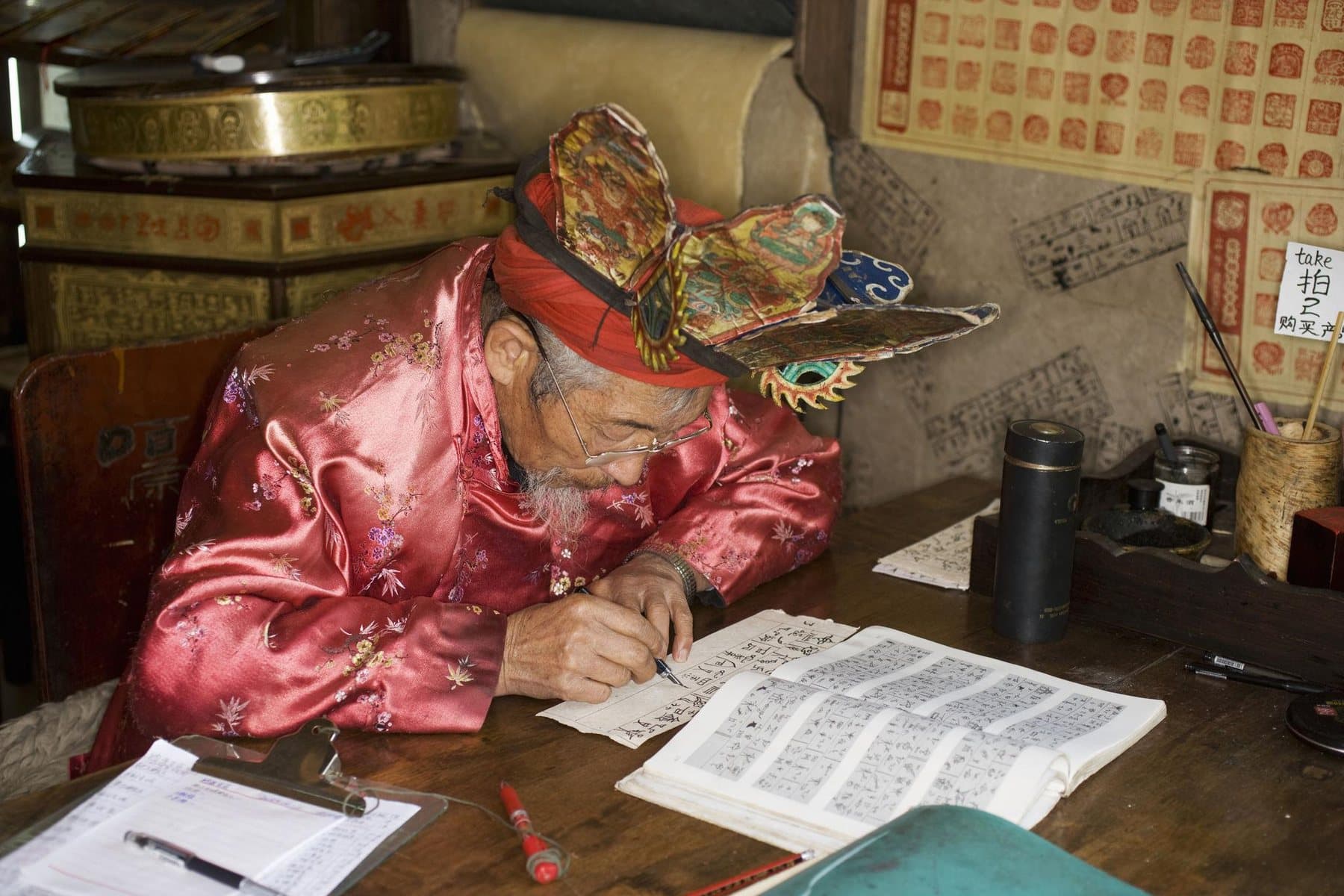 Ethnic Cultures of Yunnan — a Dongba practitioner reading a manuscript