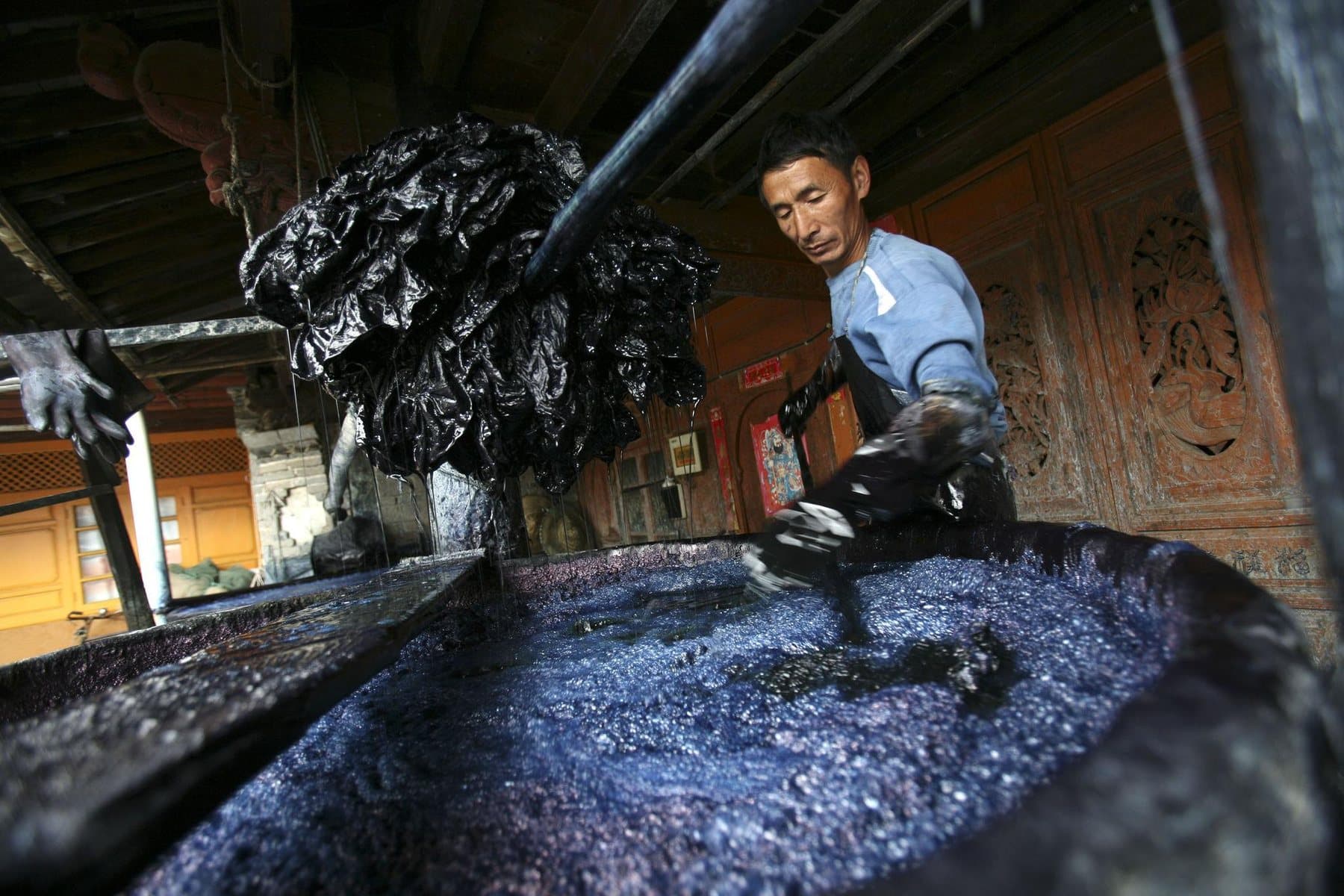Ethnic Cultures of Yunnan — an artisan working with indigo cloth