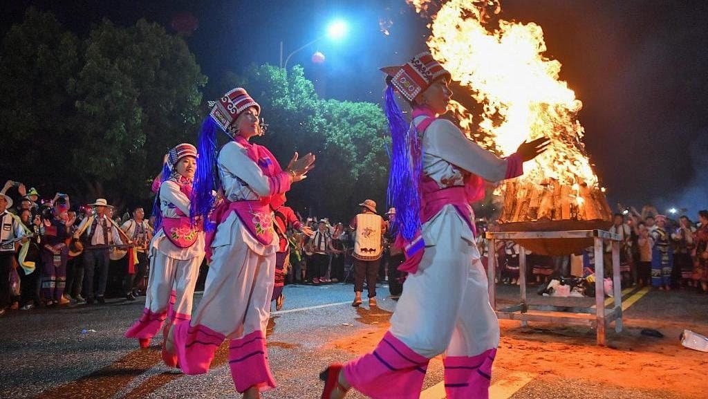 Festivals of Yunnan — dancers circling a ceremonial fire