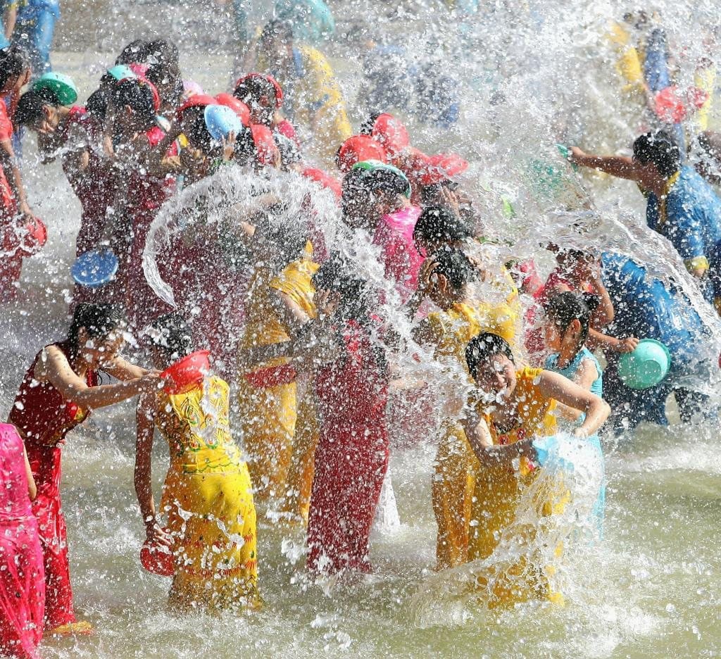 Festivals of Yunnan — crowds celebrating the Water Splashing Festival