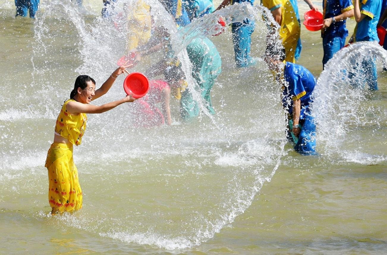 Festivals of Yunnan — a Dai festival participant throwing water