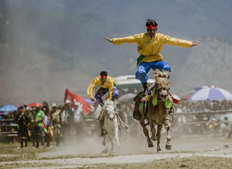 Festivals of Yunnan — a horseman displaying skill at a plateau festival