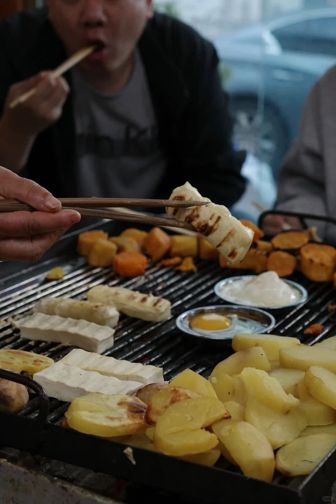 Yunnan Barbecue — diners sharing food around a tabletop grill