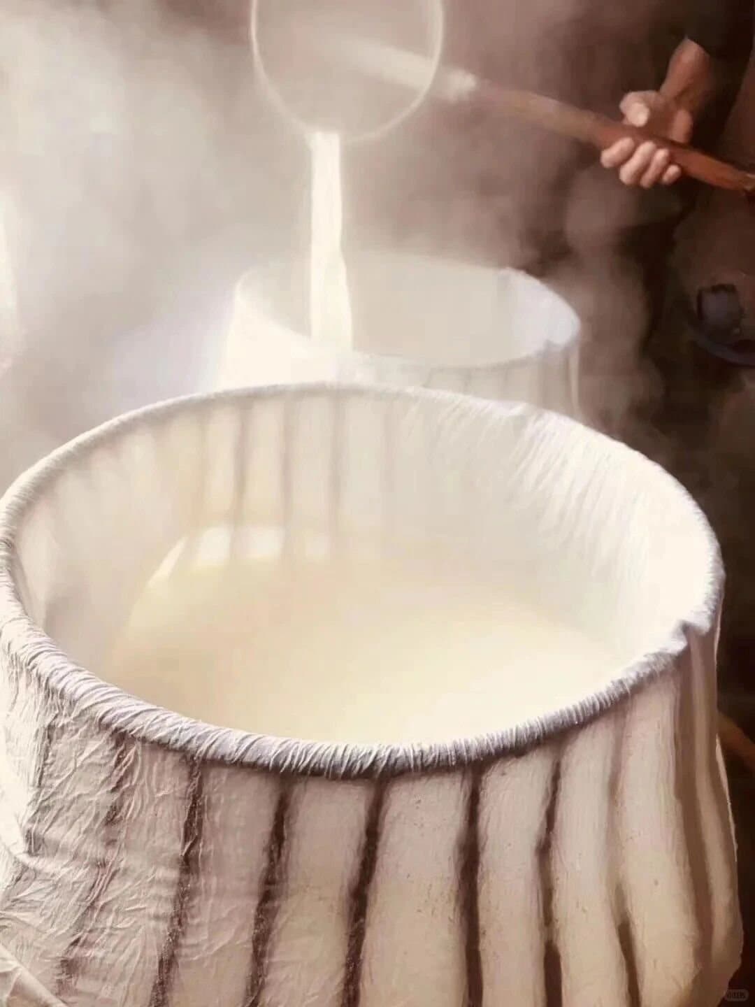 Yunnan Barbecue — soy milk being strained during tofu making