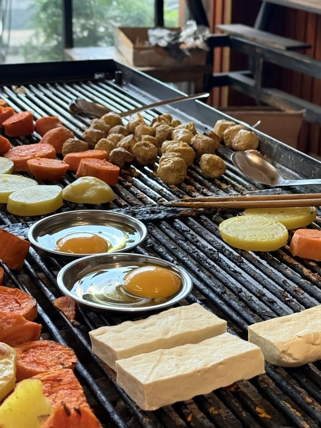 Yunnan Barbecue — skewers and vegetables arranged over a Yunnan grill