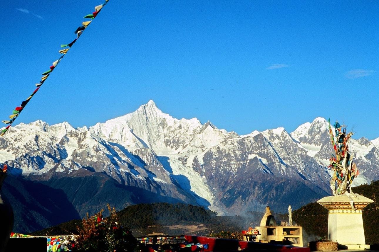 Nature and Wildlife of Yunnan — snow peaks behind a Tibetan stupa