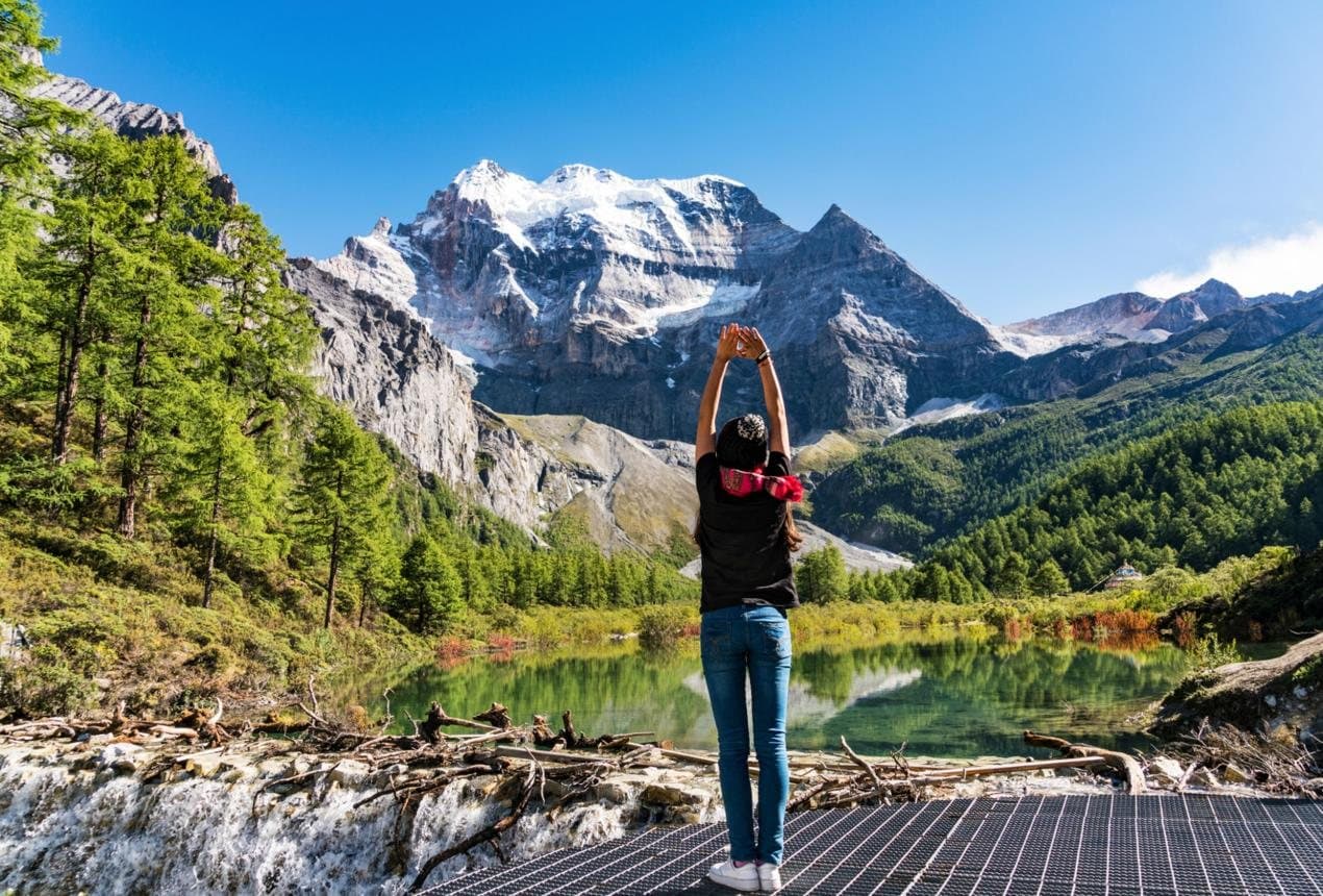Nature and Wildlife of Yunnan — a hiker facing snow mountains