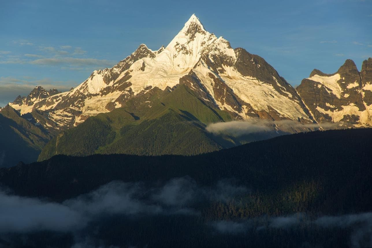 Fascinating Facts About Yunnan — a snow peak rising above clouds