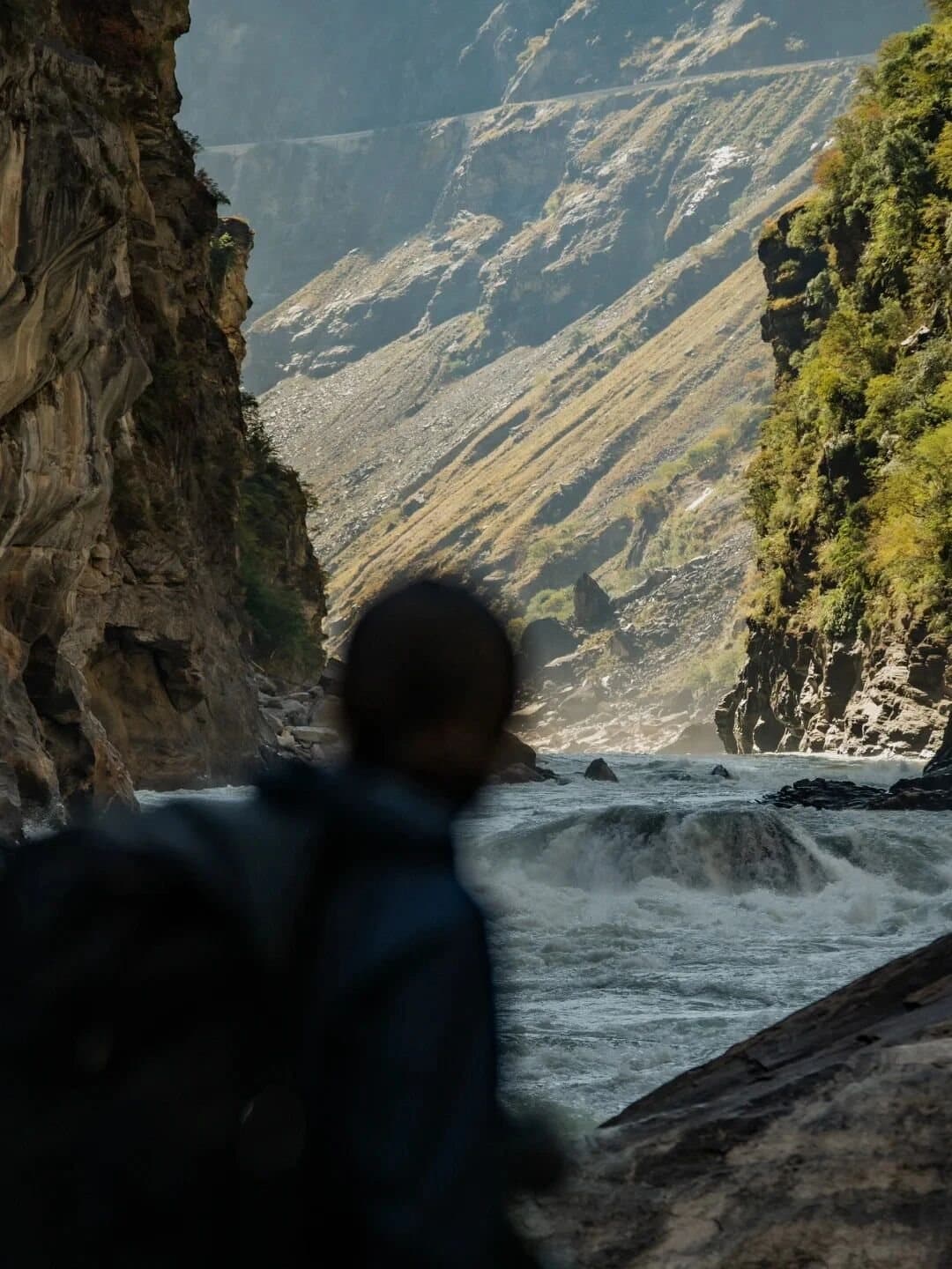 Tiger Leaping Gorge — a walker following the cliffside path