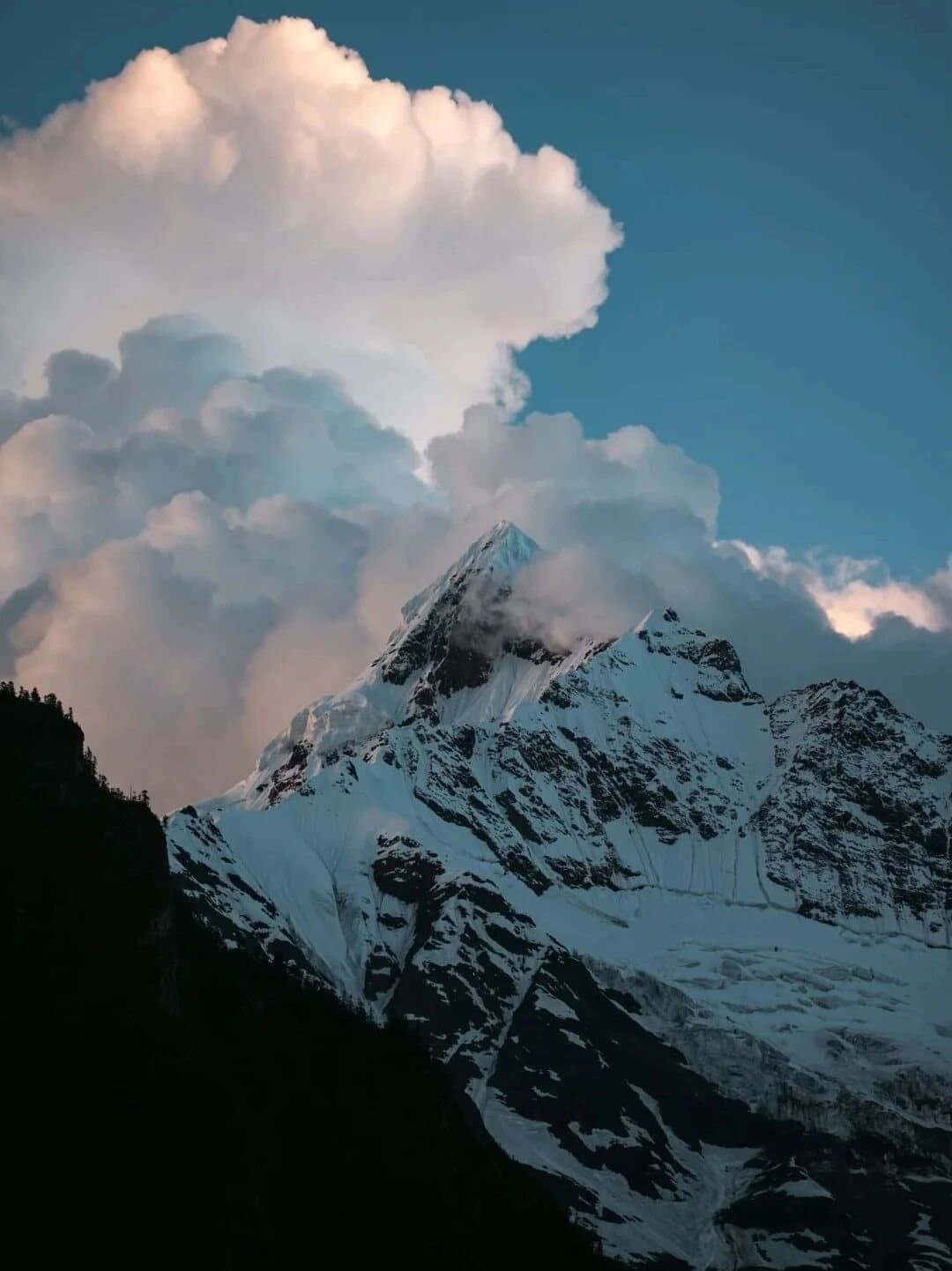 Yubeng Village — clouds gathering around a Meili snow peak