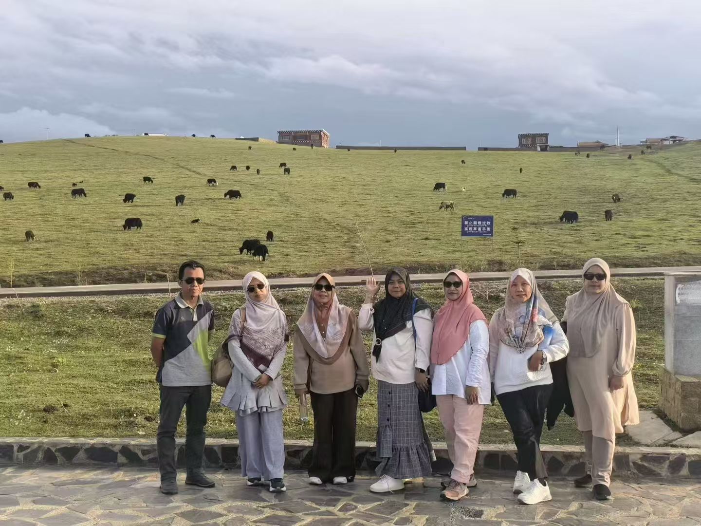 Travelers standing together on a Yunnan highland grassland