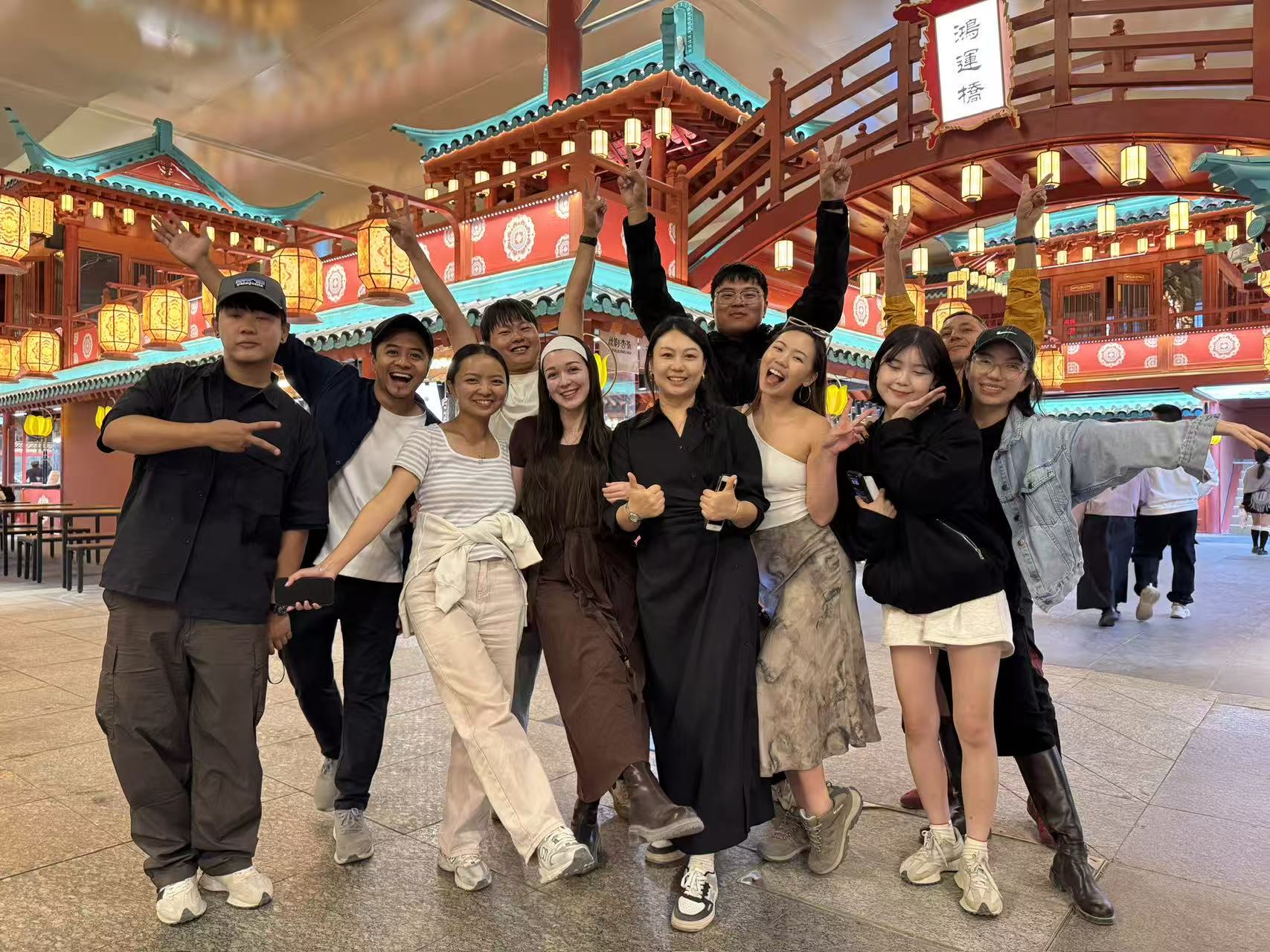 Travel group posing together at a brightly lit Yunnan night market