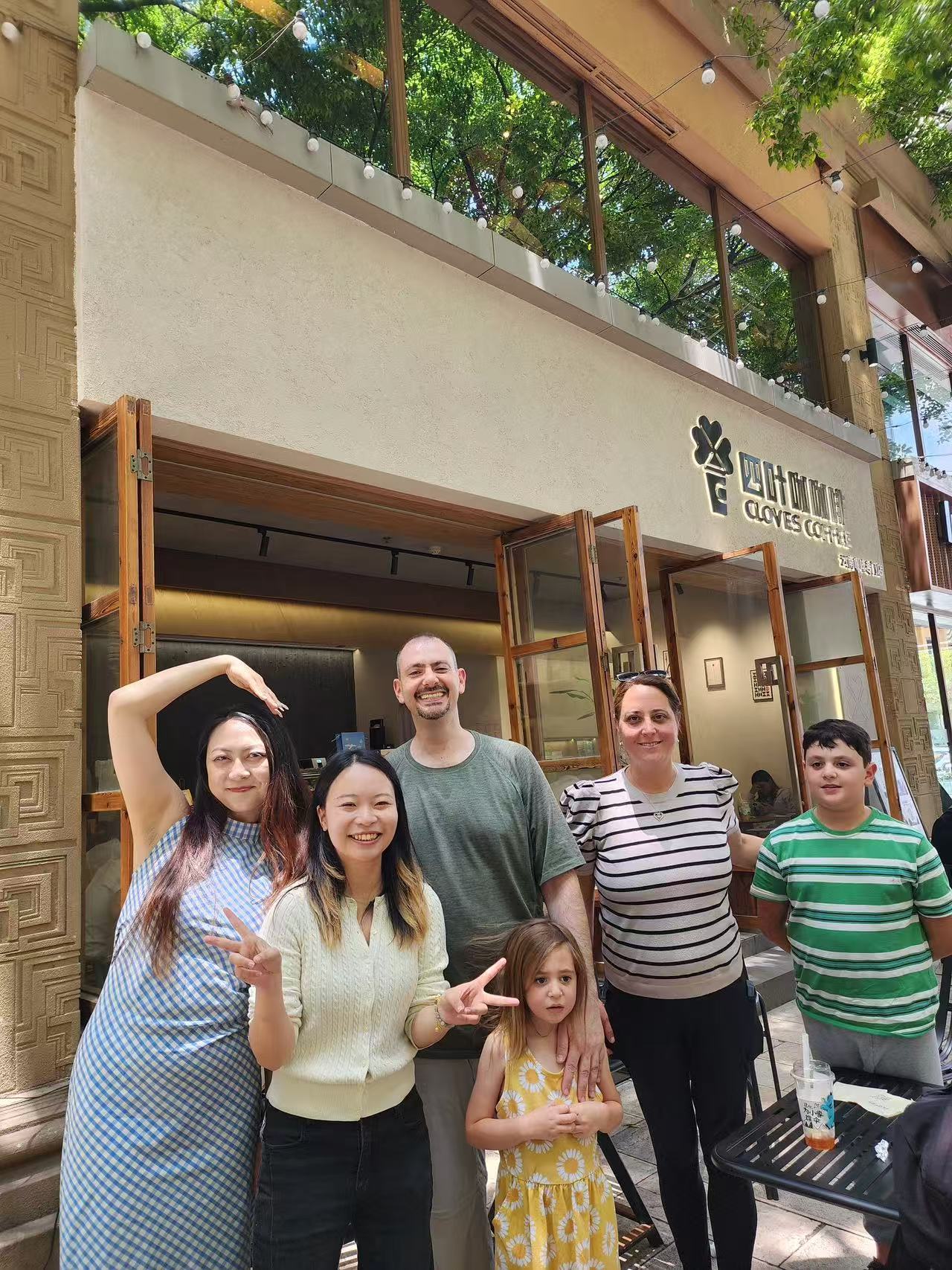 Travelers standing outside a Yunnan hotel entrance