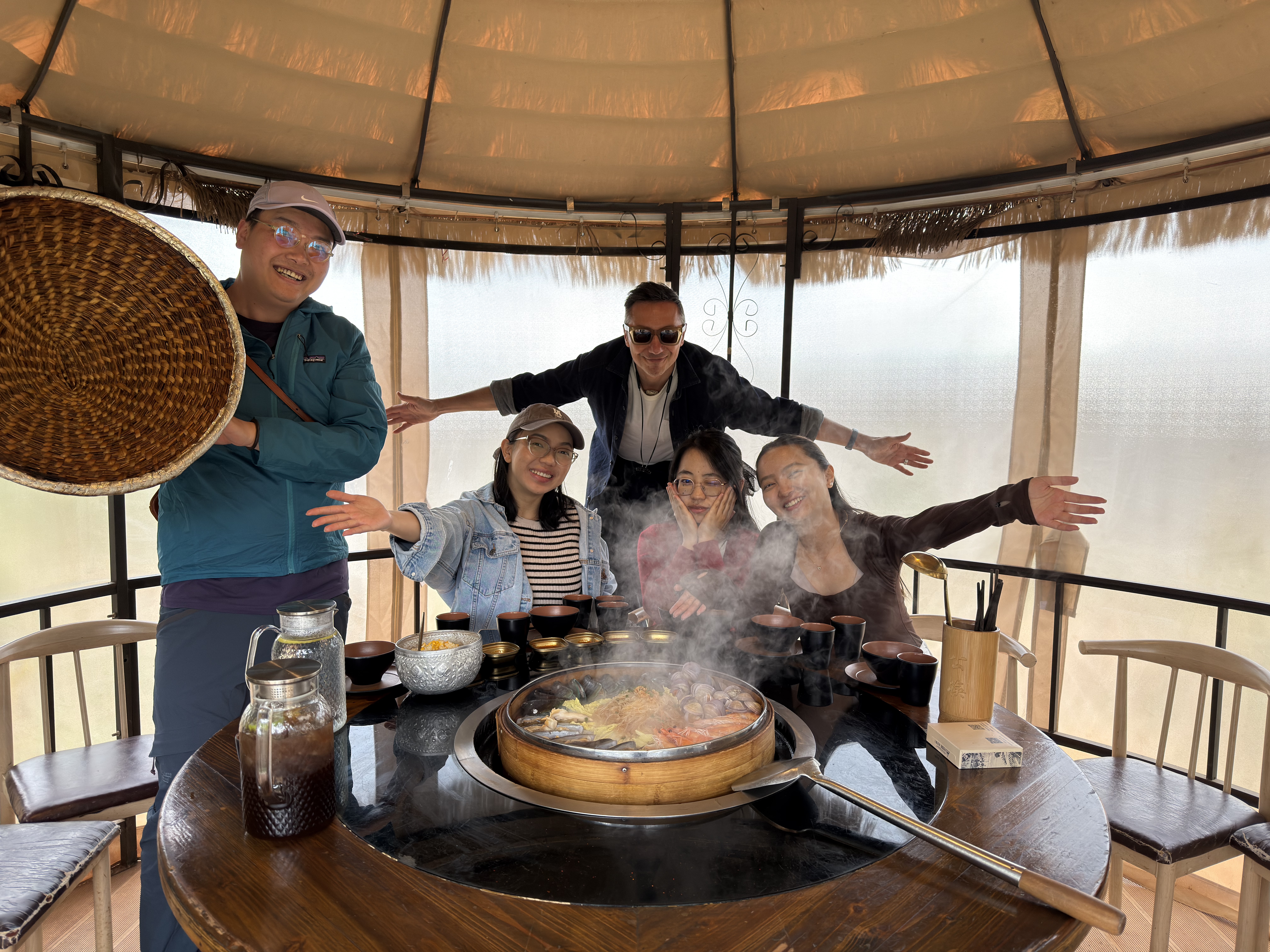 Travelers enjoying a hot pot meal in a Yunnan courtyard