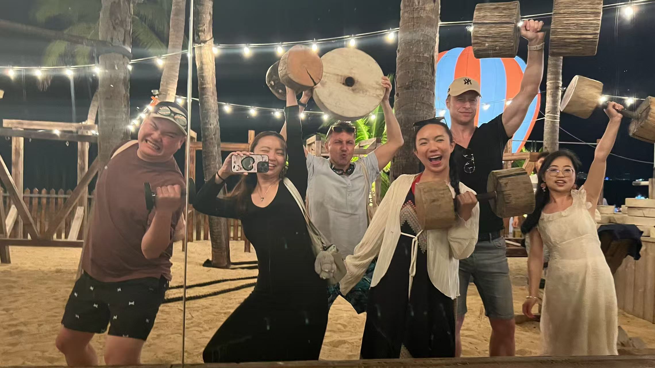 Travelers posing at night with Yunnan cultural props
